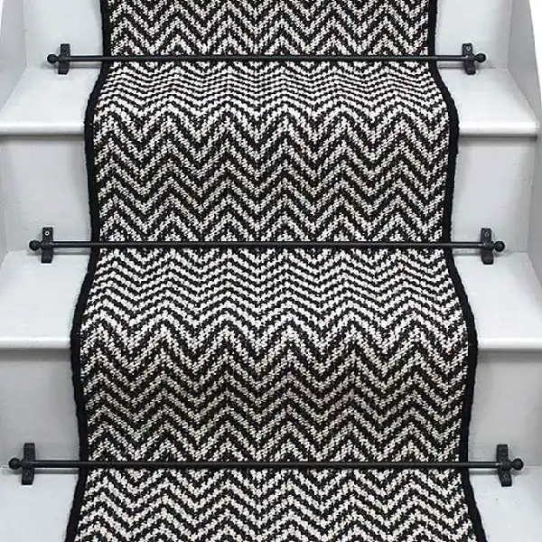 Atlantic Herringbone Orca Stair Runner on a staircase with rods.