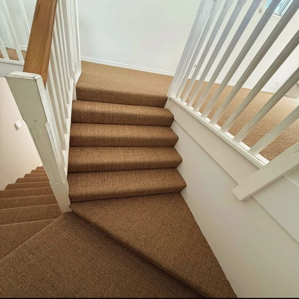 Brown textured stair carpet with sharp angled landing.