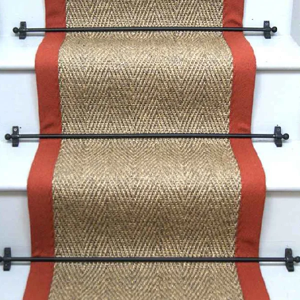 Herringbone Pewter Sisal Stair Runner on a staircase with a black border.