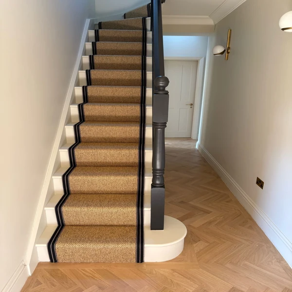Light brown stair runner with black edges.