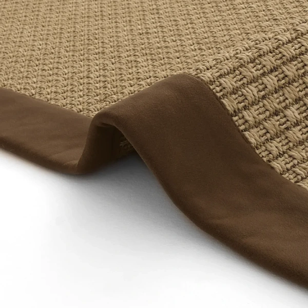 Natural sisal rug with brown suede border and folded corner
